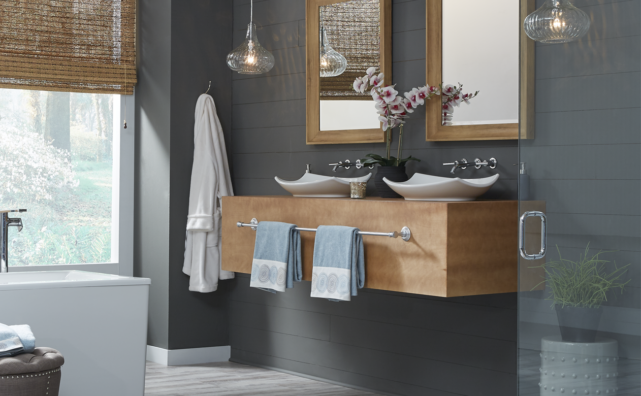 grey waterproof wood-look flooring in dark grey bathroom with floating vanity and glass shower