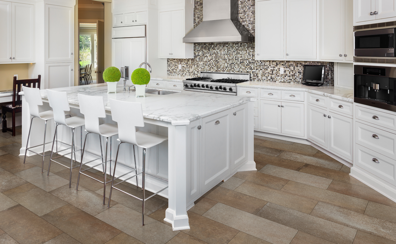 waterproof vinyl tile flooring in kitchen with white cabinetry and stone countertops