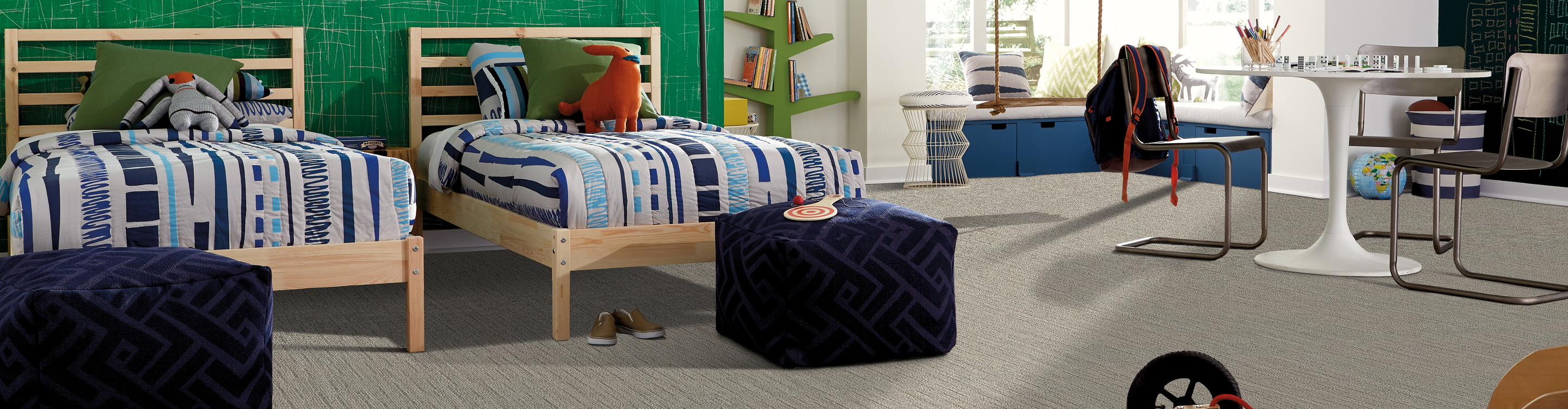 grey toned carpet in kids bedroom with wooden beds and navy cushions