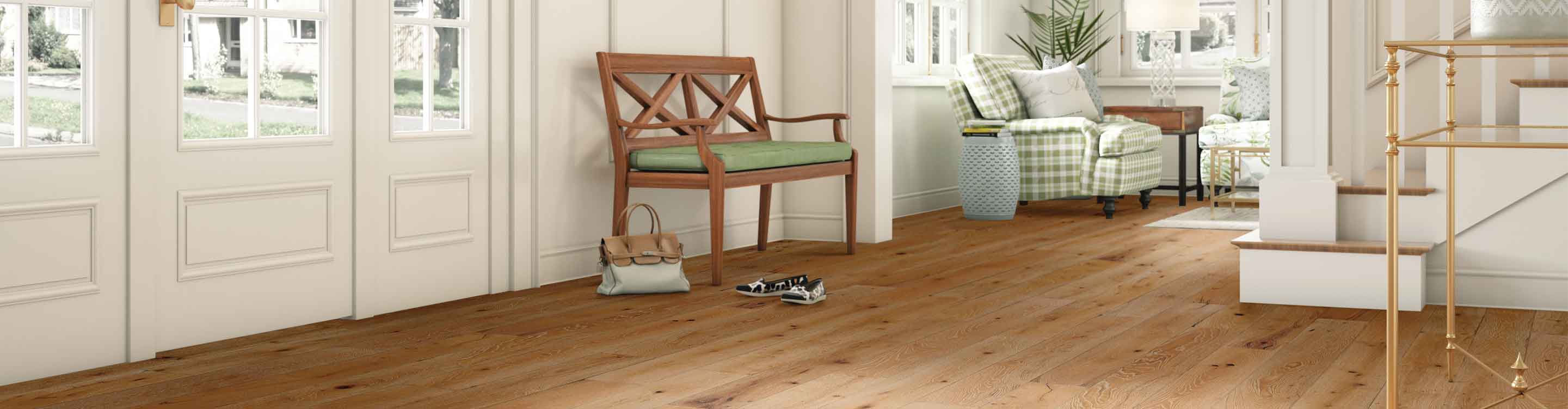 Light hardwood entryway with green cushion bench 